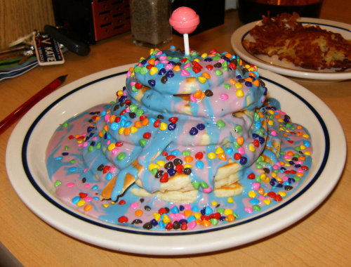 IHOP Who-Cakes
Inspired by Horton Hears a Who! : A stack of five pancakes drenched in boysenberry and blueberry syrup, covered in rainbow-colored chocolate candy and topped with a pink Dum-Dum lollipop. 
(Submitted by Katie Bailey)